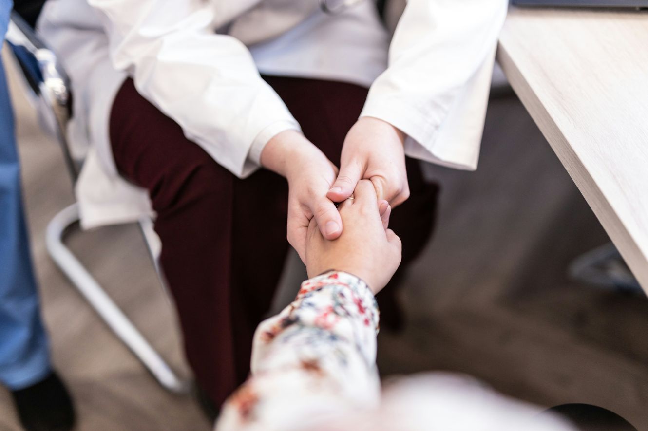 Doctor holding patients hand after issue with BARD PowerPort