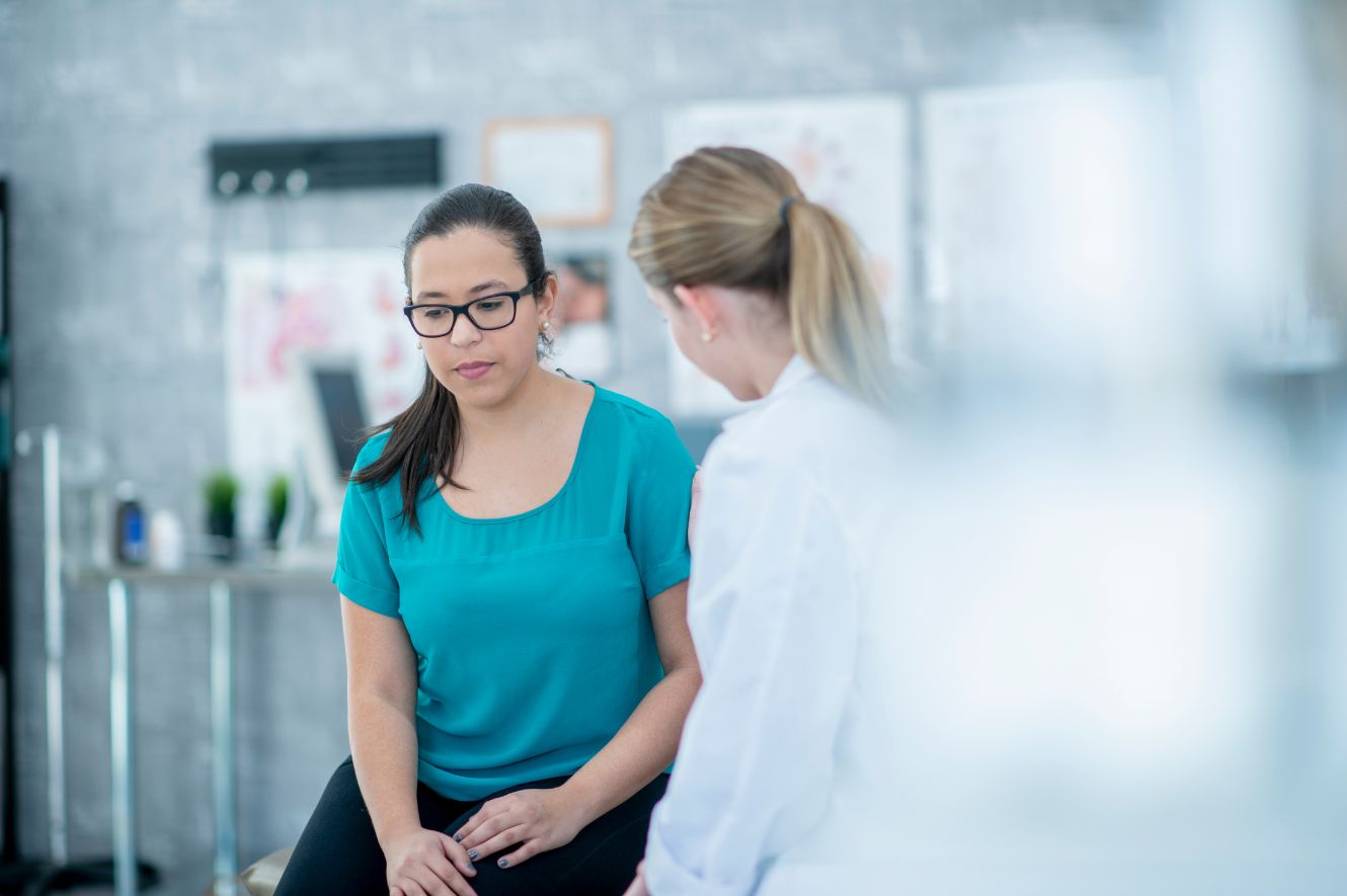 Doctor talks to her patient who has been impacted by Depo-Provera injections