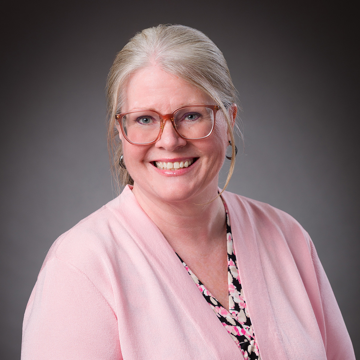 portrait of Denise Risinger of Onward Injury Law on a dark background