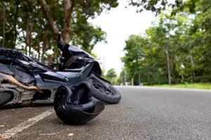 a motorcycle lying sideways with a helmet in front after an accident