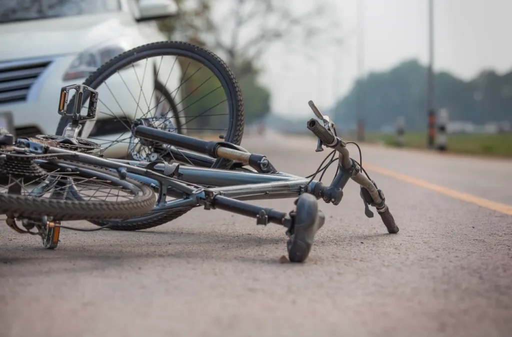 a bicycle lying sideways on a road