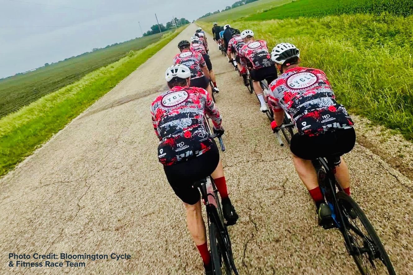 A group of bicycle riders on a rural road.