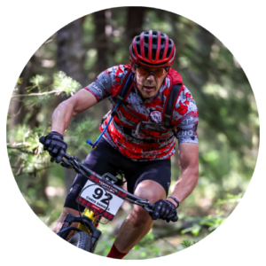 Chris Daniels with Bloomington Race Team rides his bicycle on a trail.